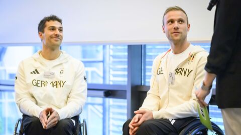 Empfang Olympia Zwei Athleten sitzen im Rollstuhl. Auf ihren Oberteilen steht das Wort "GERMANY"